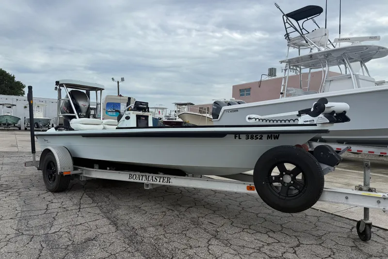 The Image of 2005 Maverick 18 HPX-V boat on trailer, parked outdoors under cloudy sky. - 1