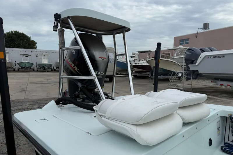 Slide: The Image of 2005 Maverick 18 HPX-V boat with Yamaha engine, docked with white cushions. - 5