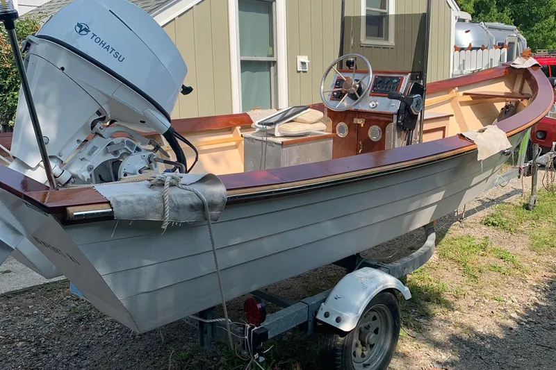 Slide: The Image of 2009 Simmons Sea Skiff 18 boat with Tohatsu motor on trailer, parked outdoors. - 3