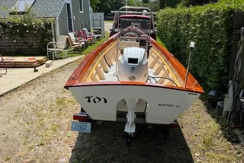 Slide: The Image of 2009 Simmons Sea Skiff 18 boat on trailer, parked outdoors near a house. - 7