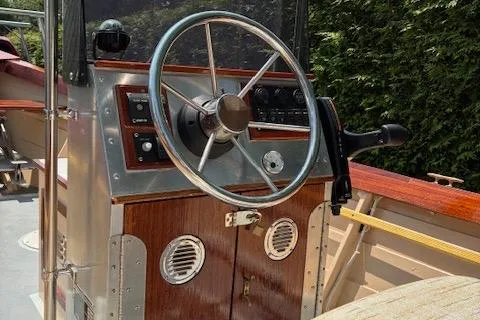 Slide: The Image of Steering console of a 2009 Simmons Sea Skiff 18 boat with wooden accents. - 9