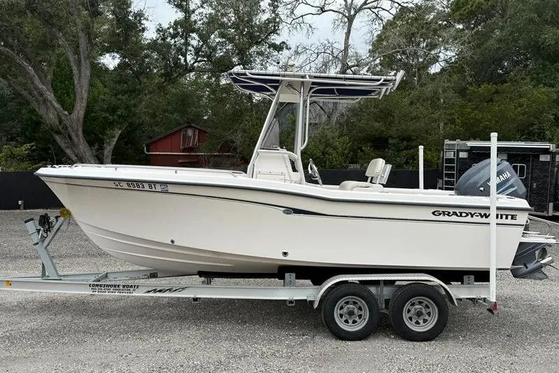 Slide: The Image of 2005 Grady-White Escape 209 boat on trailer, parked outdoors. - 0