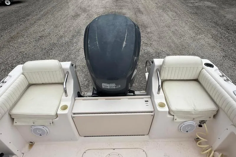 Slide: The Image of 2005 Grady-White Escape 209 boat interior with seating and outboard motor. - 10