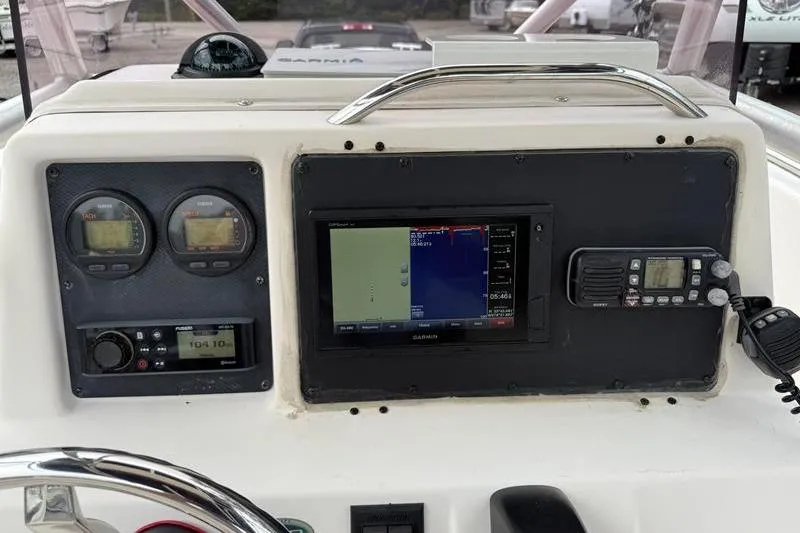 Slide: The Image of 2005 Grady-White Escape 209 dashboard with Garmin navigation and communication equipment. - 17