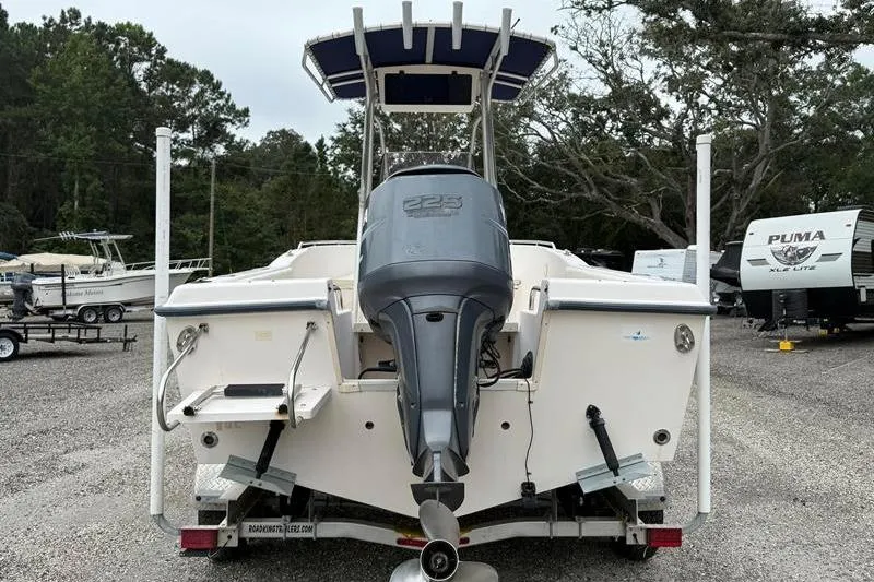 Slide: The Image of 2005 Grady-White Escape 209 boat with outboard motor, parked on a trailer. - 2