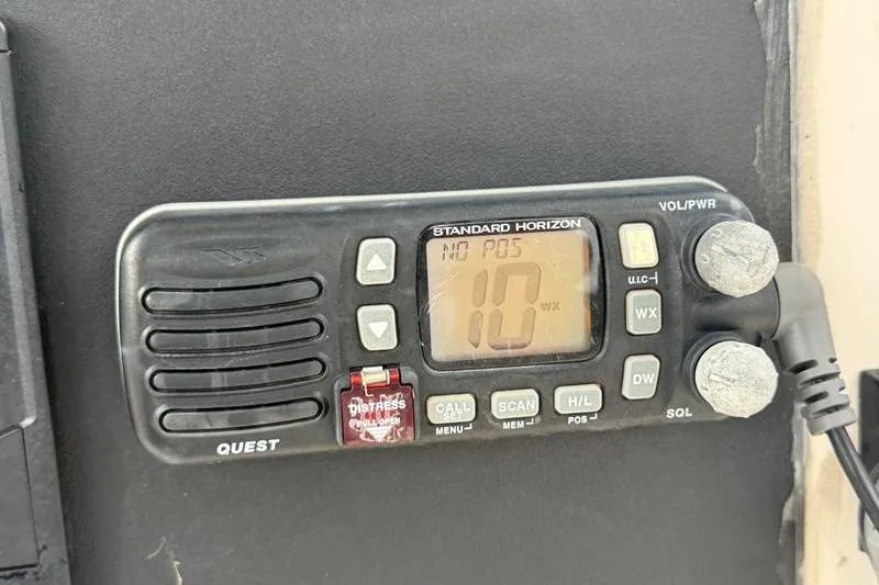 Slide: The Image of Standard Horizon marine radio on a 2005 Grady-White Escape 209 boat dashboard. - 20