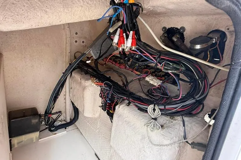 Slide: The Image of 2005 Grady-White Escape 209 boat wiring and electronics compartment. - 23