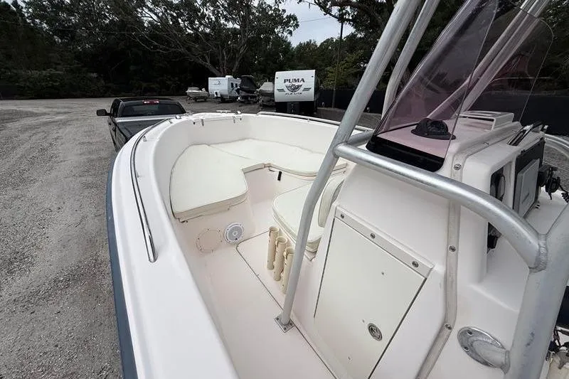 Slide: The Image of 2005 Grady-White Escape 209 boat interior with seating and console, parked outdoors. - 24