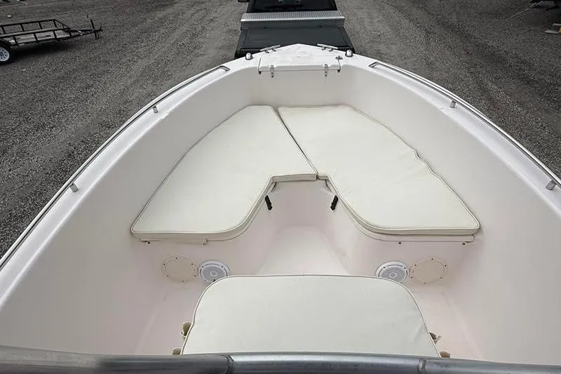 Slide: The Image of 2005 Grady-White Escape 209 boat interior with cushioned seating and storage compartments. - 27