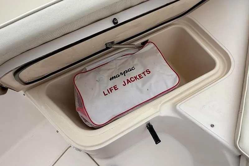 Slide: The Image of Storage compartment with life jackets on a 2005 Grady-White Escape 209 boat. - 29