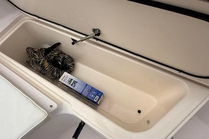Slide: The Image of Storage compartment of 2005 Grady-White Escape 209 boat with rope and box inside. - 30