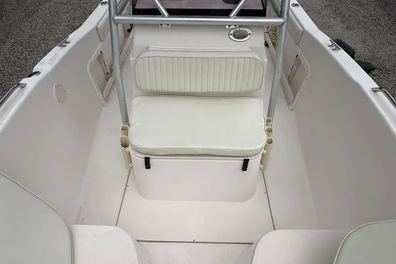 Slide: The Image of 2005 Grady-White Escape 209 boat interior with white seating and storage. - 32