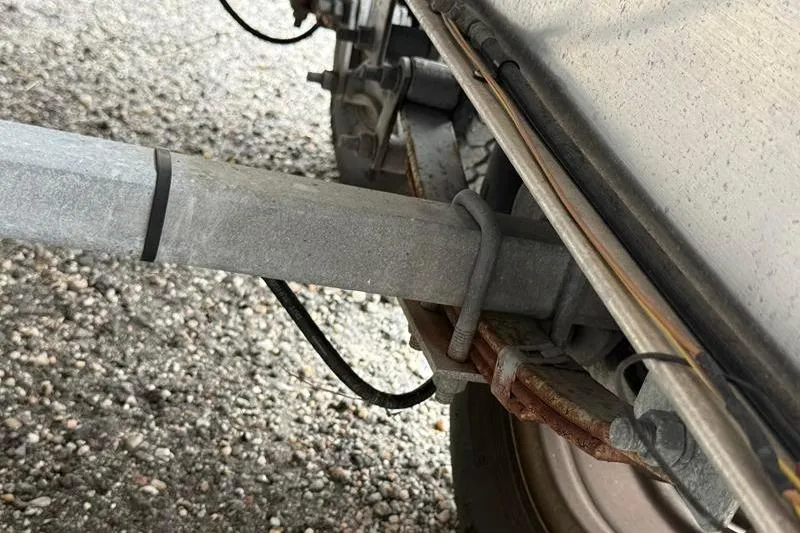 Slide: The Image of Close-up of a 2005 Grady-White Escape 209 trailer axle and suspension system. - 34