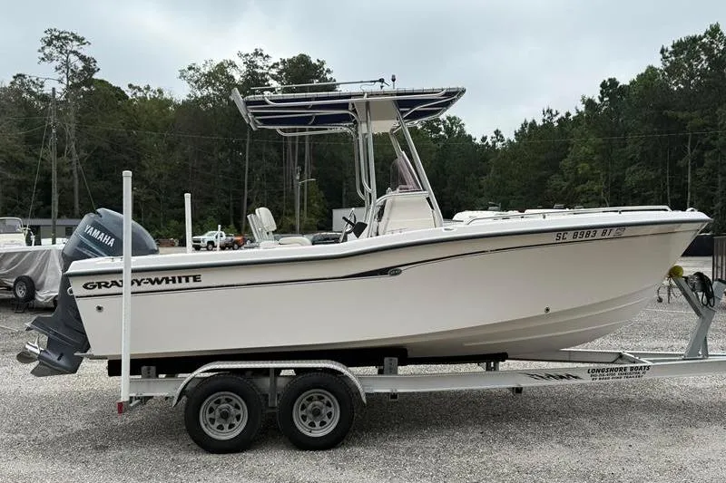 Slide: The Image of 2005 Grady-White Escape 209 boat on trailer, parked outdoors with Yamaha engine. - 4
