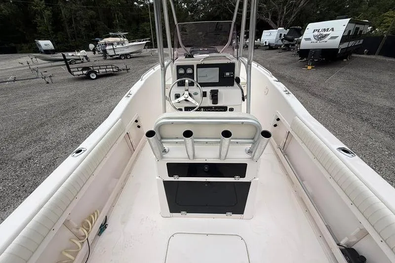 Slide: The Image of 2005 Grady-White Escape 209 boat interior with steering console and rod holders. - 7