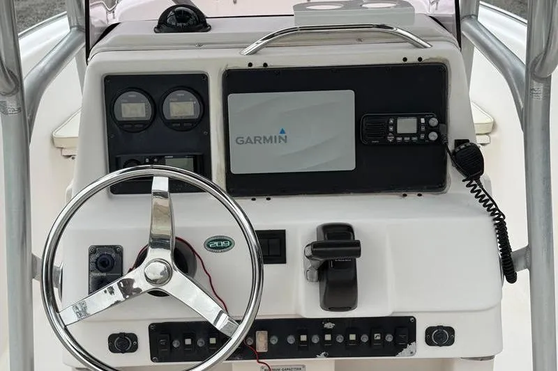 Slide: The Image of 2005 Grady-White Escape 209 boat dashboard with Garmin navigation system and steering wheel. - 9