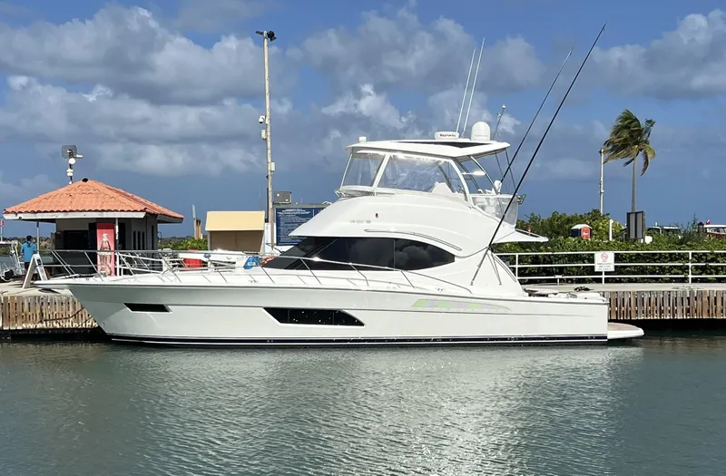 The Image of 2016 Riviera 45 OPEN yacht docked under a clear blue sky. - 0