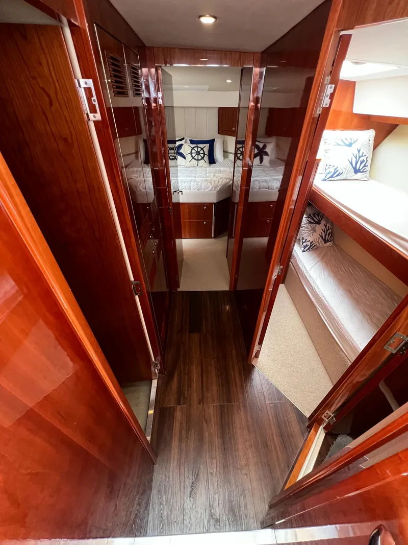 Slide: The Image of Luxurious interior of 2016 Riviera 45 OPEN yacht with wood finishes and cozy bedding. - 12