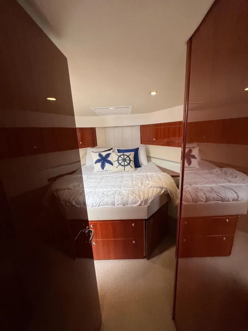 Slide: The Image of Interior of 2016 Riviera 45 OPEN yacht with cozy bedroom and nautical decor. - 16
