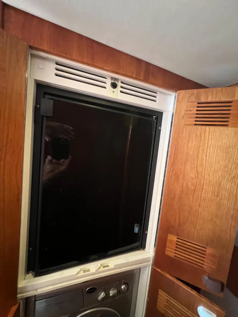 Slide: The Image of Interior of 2016 Riviera 45 OPEN yacht with wooden cabinetry and built-in appliance. - 19