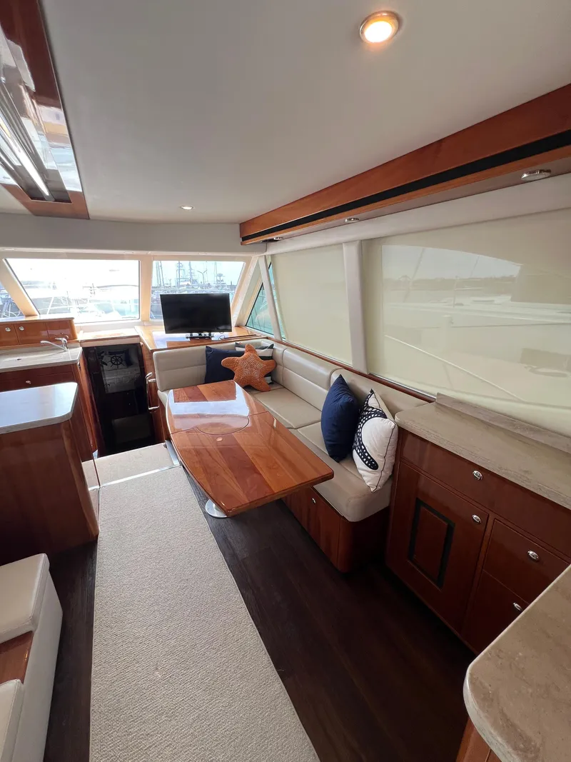 Slide: The Image of Luxurious interior of a 2016 Riviera 45 OPEN yacht with elegant seating and wooden accents. - 4