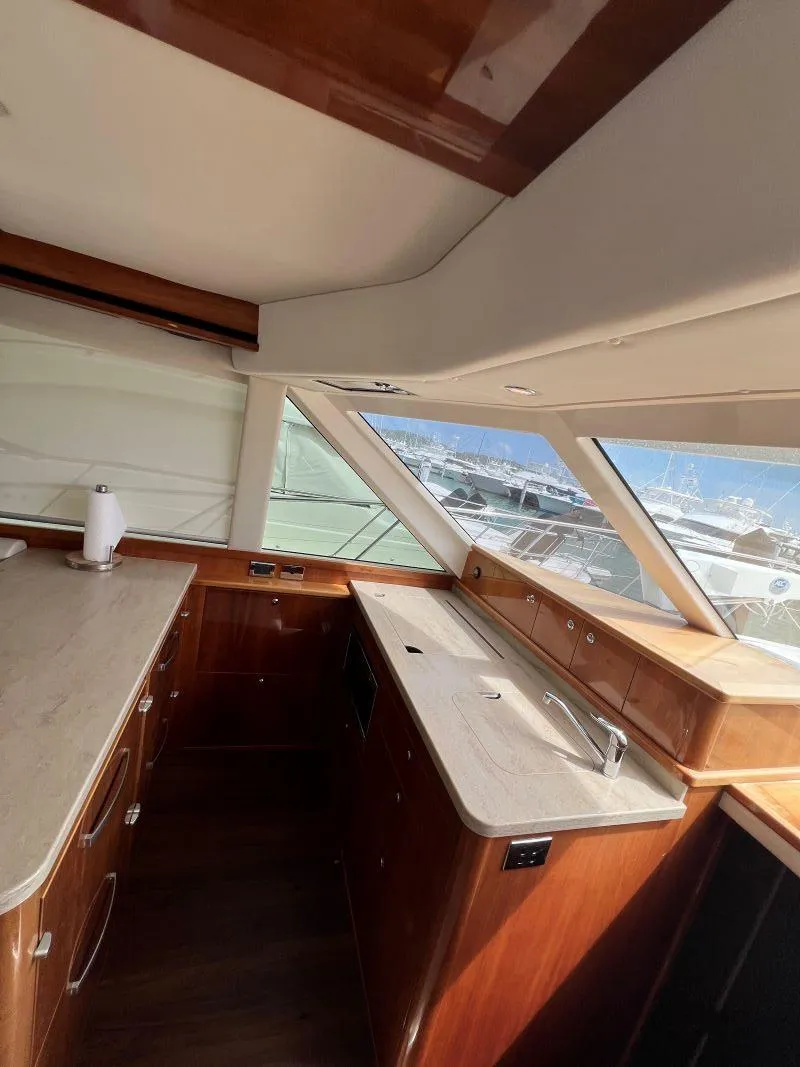 Slide: The Image of Interior of 2016 Riviera 45 OPEN yacht with modern kitchen and panoramic windows. - 8