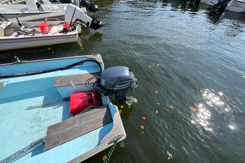 Slide: The Image of 1986 Stur-Dee 16 Dory boat with Yamaha outboard motor on calm water. - 5