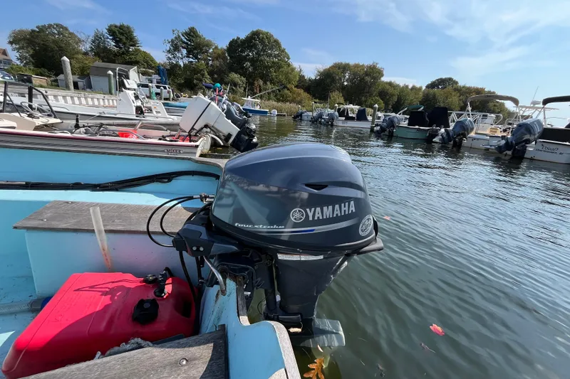 Slide: The Image of 1986 Stur-Dee 16 Dory with Yamaha outboard motor docked in a marina. - 7