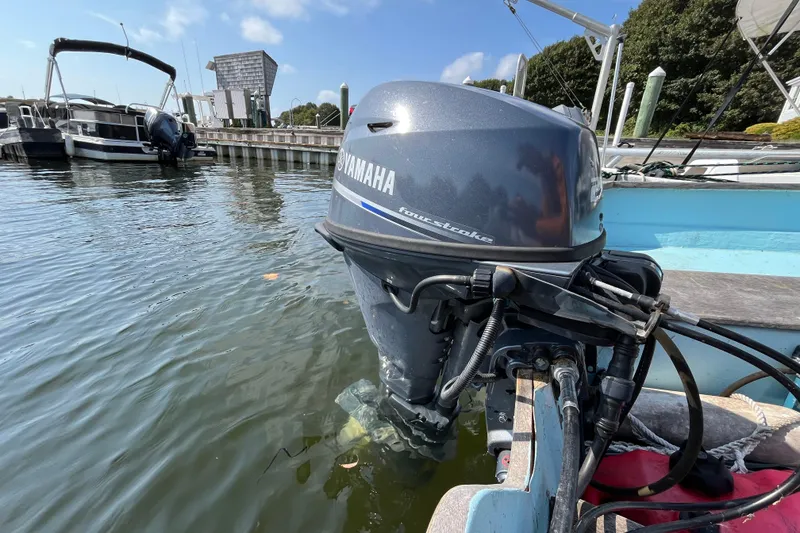 Slide: The Image of Outboard motor on 1986 Stur-Dee 16 Dory boat docked in marina. - 9