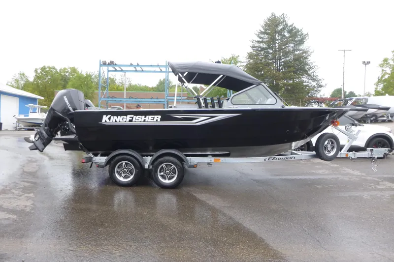 The Image of 2026 KingFisher 2025 Escape boat on trailer, black exterior, parked outdoors. - 0