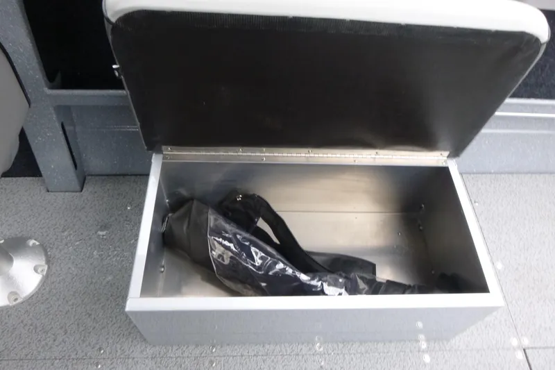 Slide: The Image of Open storage compartment in 2026 KingFisher 2025 Escape boat, featuring a black interior bag. - 14