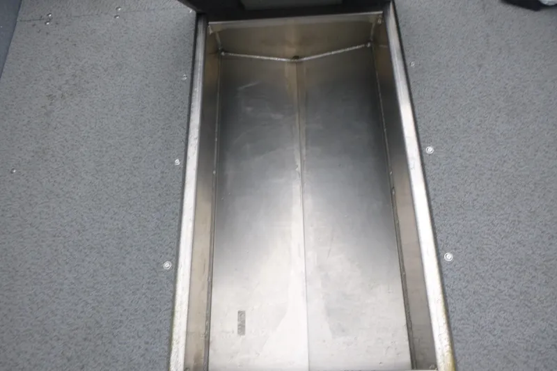 Slide: The Image of Storage compartment in 2026 KingFisher 2025 Escape boat, featuring metal interior and carpeted edges. - 19