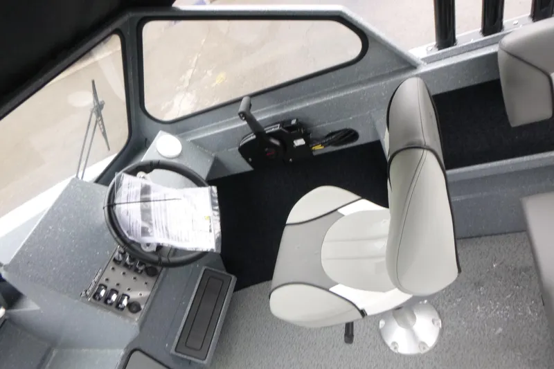 Slide: The Image of Interior of 2026 KingFisher 2025 Escape boat, featuring steering wheel and captain's chair. - 9