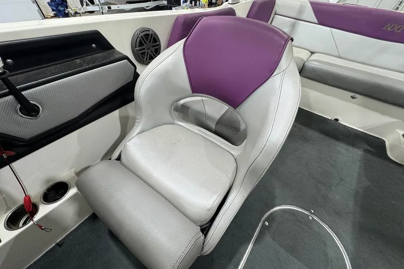 Slide: The Image of 2016 MasterCraft NXT22 interior with purple and gray seating, featuring a sleek design. - 10