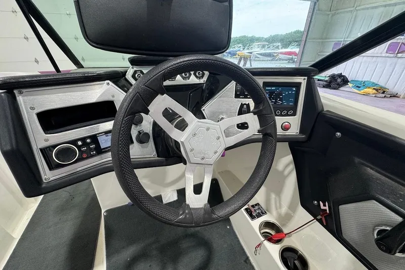 Slide: The Image of 2016 MasterCraft NXT22 boat dashboard with steering wheel and control panel. - 11