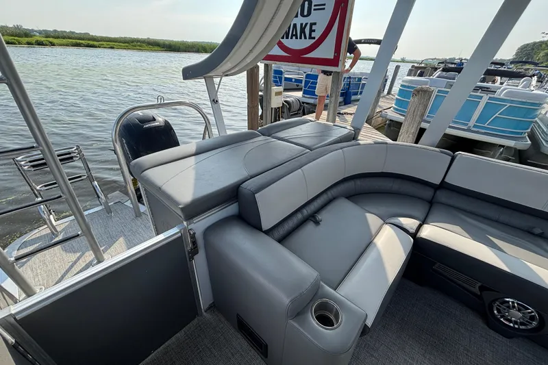 Slide: The Image of 2023 TAHOE AVALON Cascade pontoon boat interior with plush seating and lake view. - 11
