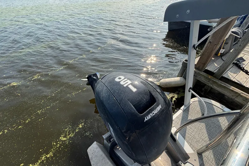 Slide: The Image of 2023 TAHOE AVALON Cascade boat with Mercury outboard motor by a dock. - 3