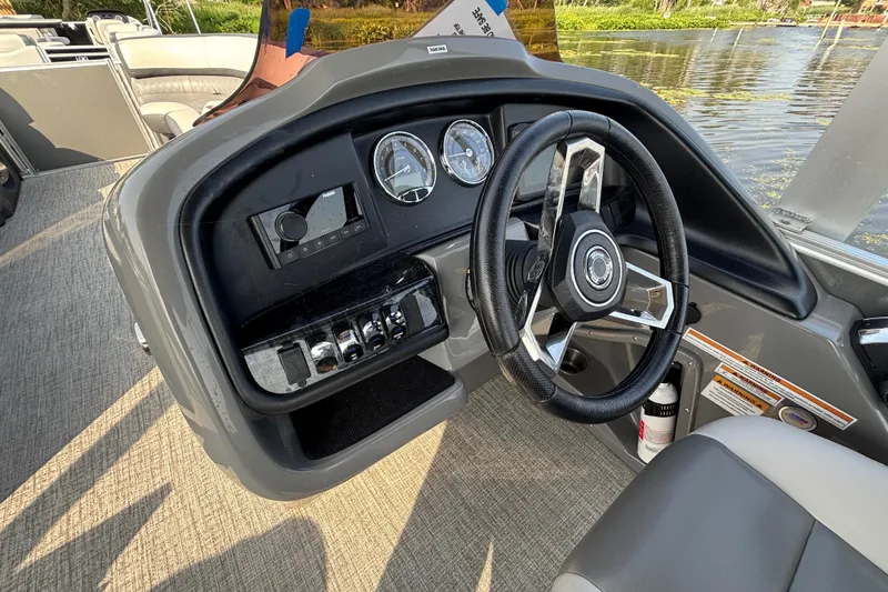 Slide: The Image of 2023 TAHOE AVALON Cascade boat dashboard with steering wheel and gauges. - 6
