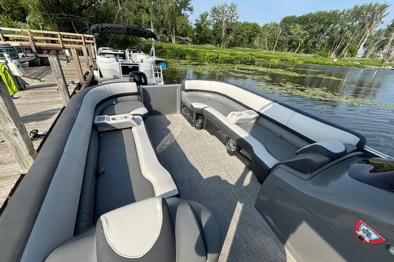 Slide: The Image of 2023 TAHOE AVALON Cascade pontoon boat with spacious seating, docked by a serene lake. - 9