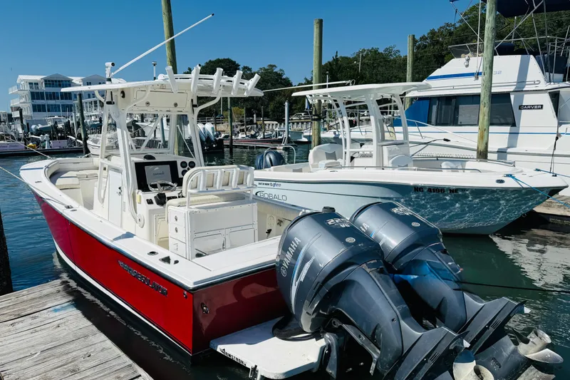Slide: The Image of 2003 Regulator 26 Center Console boat docked with twin Yamaha engines. - 4