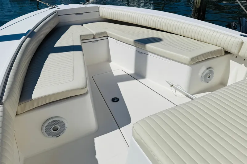 Slide: The Image of 2003 Regulator 26 Center Console boat interior with cushioned seating and speakers. - 7