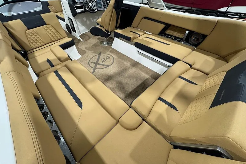 Slide: The Image of 2021 MasterCraft X24 boat interior with tan upholstery and modern design. - 10