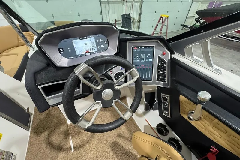Slide: The Image of 2021 MasterCraft X24 boat dashboard with modern steering and digital controls. - 12