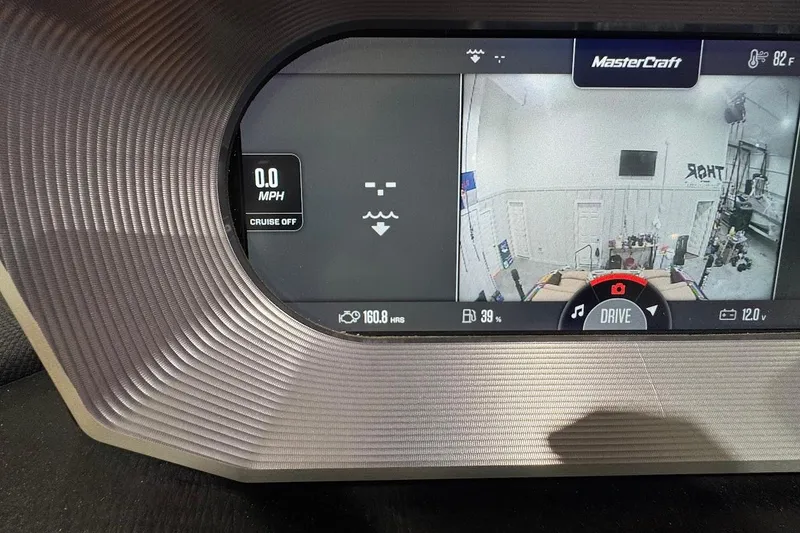 Slide: The Image of Dashboard of 2021 MasterCraft X24 boat showing speed, camera, and controls. - 13