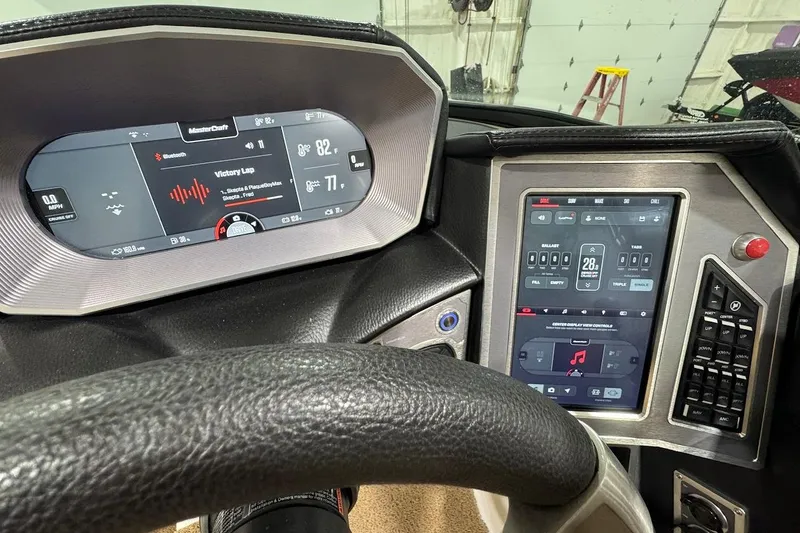 Slide: The Image of 2021 MasterCraft X24 dashboard with digital displays and control panel in a boat interior. - 14