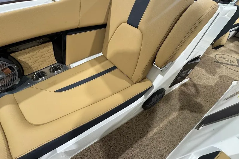 Slide: The Image of 2021 MasterCraft X24 boat interior with tan seating and cup holders. - 17