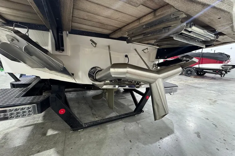 Slide: The Image of 2021 MasterCraft X24 boat underside with exhaust and propeller details. - 3
