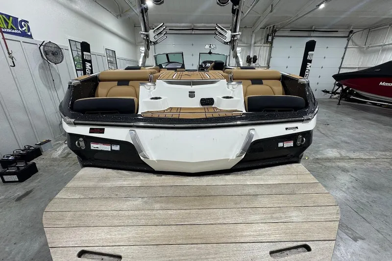 Slide: The Image of 2021 MasterCraft X24 boat in a garage, showcasing luxury seating and sleek design. - 4