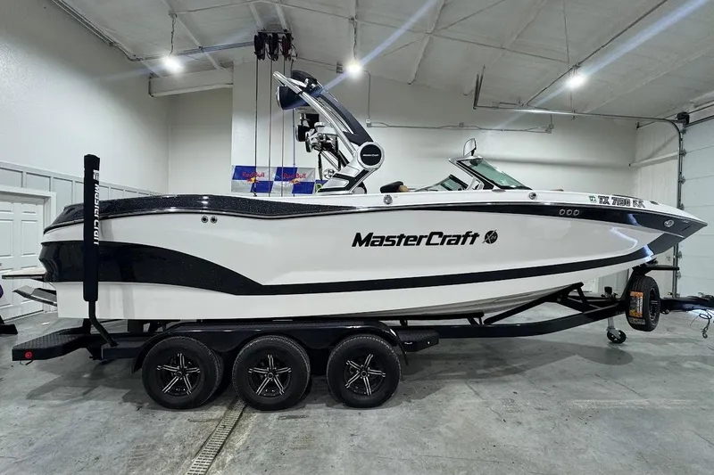 Slide: The Image of 2021 MasterCraft X24 boat on trailer in indoor storage facility. - 6