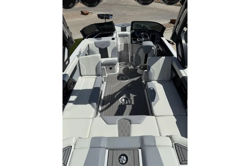 Slide: The Image of 2023 MasterCraft XT24 boat interior with sleek white seating and modern design. - 10